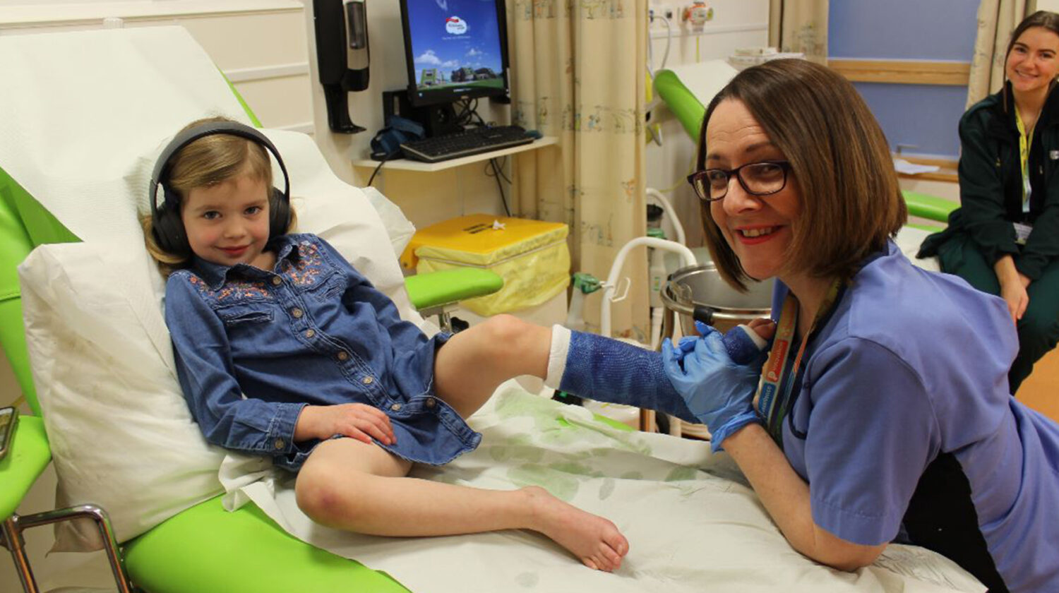 nurse and child patient smiling