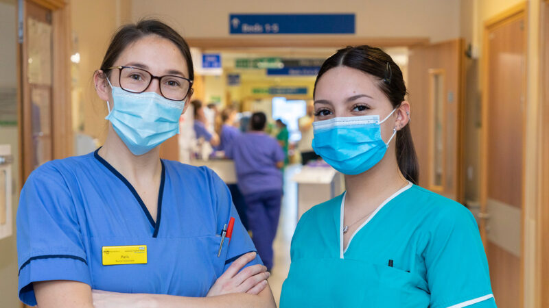 nurses in masks smiling